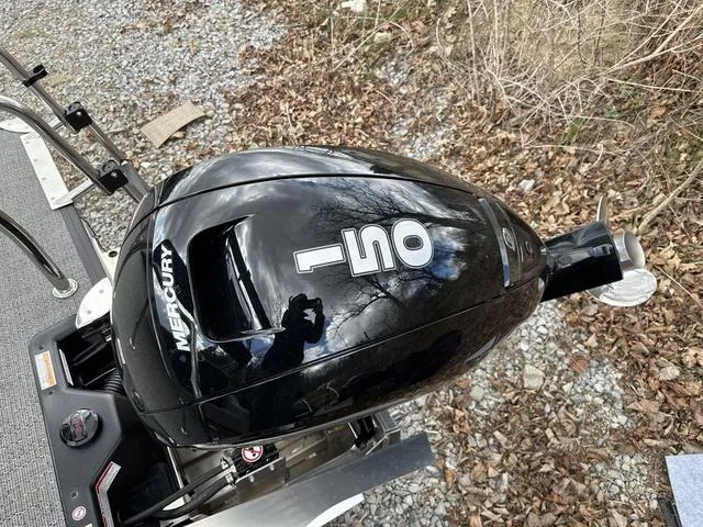 Slide: The Image of Mercury 150 outboard motor on 2025 Barletta A22UC boat, surrounded by leaves. - 37