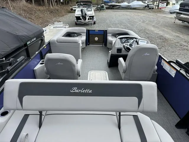 Slide: The Image of 2025 Barletta A22UC boat interior with gray seating and steering console. - 39