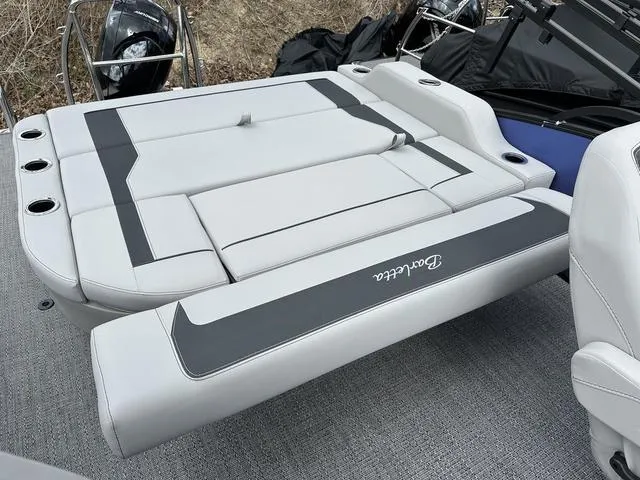Slide: The Image of 2025 Barletta Boats A22UC with sleek gray seating and cup holders on deck. - 40