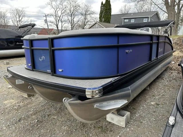 Slide: The Image of 2025 Barletta Boats A22UC pontoon with blue exterior, parked on a gravel surface. - 5