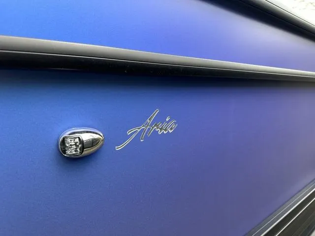 Slide: The Image of 2025 Barletta Boats A22UC Aria model, close-up of sleek blue exterior design. - 6