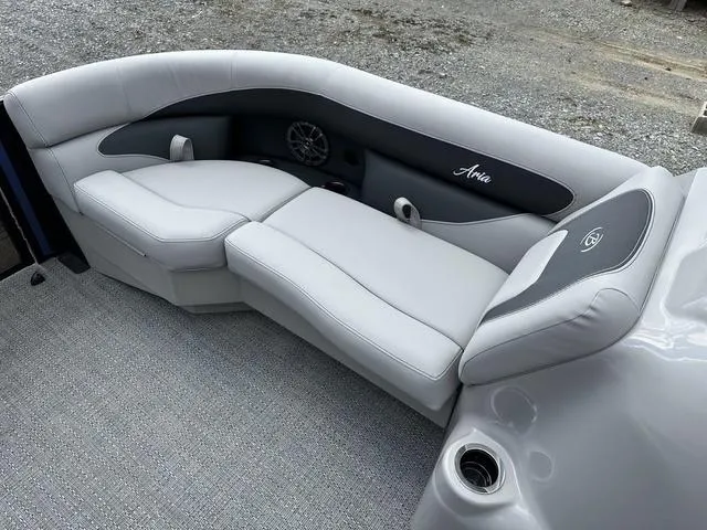 Slide: The Image of 2025 Barletta Boats A22UC interior with gray cushioned seating and cup holder. - 8
