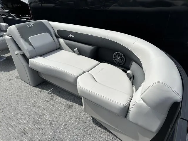 Slide: The Image of 2025 Barletta Boats A22QC luxury seating with gray upholstery and integrated speaker. - 11