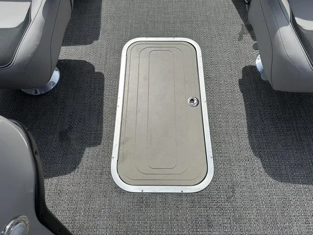 Slide: The Image of 2025 Barletta Boats A22QC floor hatch with gray carpet and seating. - 14