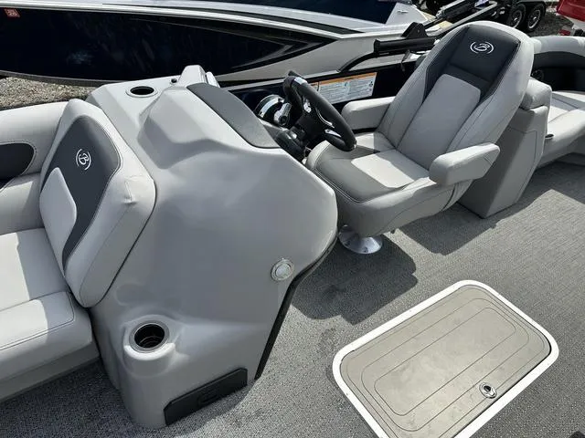 Slide: The Image of 2025 Barletta Boats A22QC interior with gray seating and steering console. - 15