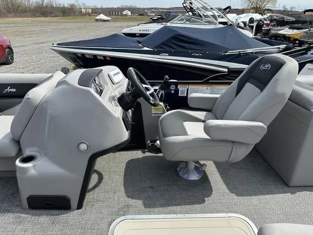 Slide: The Image of 2025 Barletta Boats A22QC interior with captain's chair and control console. - 16