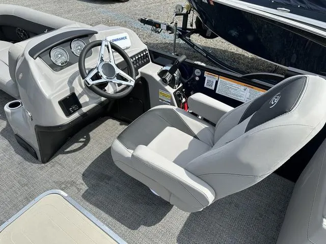 Slide: The Image of 2025 Barletta Boats A22QC helm with steering wheel and captain's chair. - 18