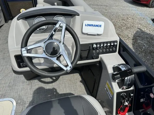 Slide: The Image of Steering console of 2025 Barletta Boats A22QC with Lowrance system and controls. - 19