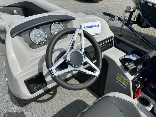 Slide: The Image of 2025 Barletta A22QC boat dashboard with steering wheel and Lowrance system. - 20