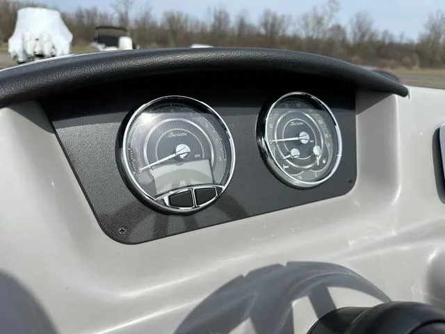 Slide: The Image of Dashboard of 2025 Barletta Boats A22QC with dual gauges, outdoor setting. - 21
