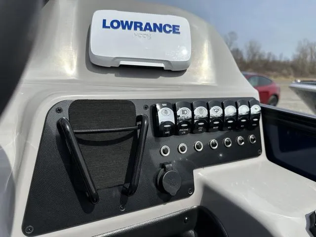 Slide: The Image of Control panel of 2025 Barletta Boats A22QC with Lowrance device and switches. - 22