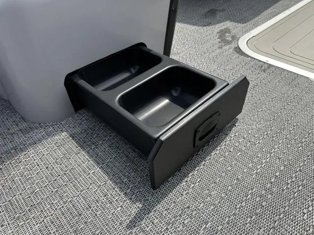 Slide: The Image of Barletta Boats A22QC 2025 model with dual cup holder drawer on textured flooring. - 24