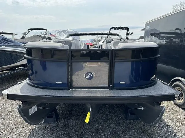 Slide: The Image of 2025 Barletta Boats A22QC pontoon boat, rear view, parked on gravel. - 3