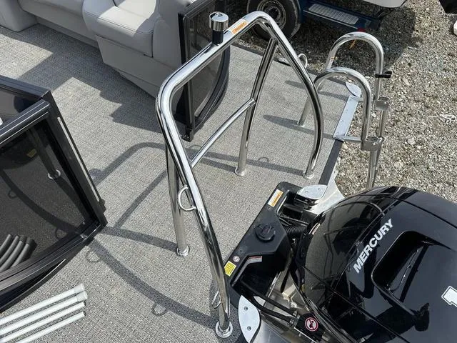 Slide: The Image of 2025 Barletta Boats A22QC with Mercury engine, featuring sleek chrome railings and seating. - 34