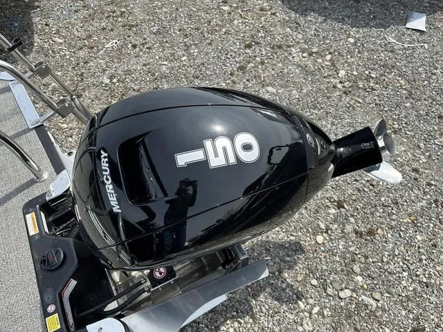 Slide: The Image of Outboard motor on 2025 Barletta Boats A22QC, gravel background. - 35