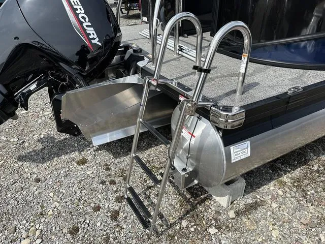 Slide: The Image of 2025 Barletta A22QC boat with Mercury engine and stainless steel ladder on gravel surface. - 36