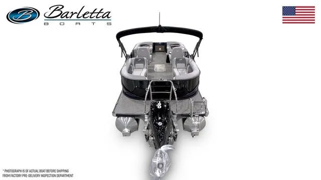 Slide: The Image of 2025 Barletta A22QC pontoon boat, rear view, with seating and canopy, American flag displayed. - 39