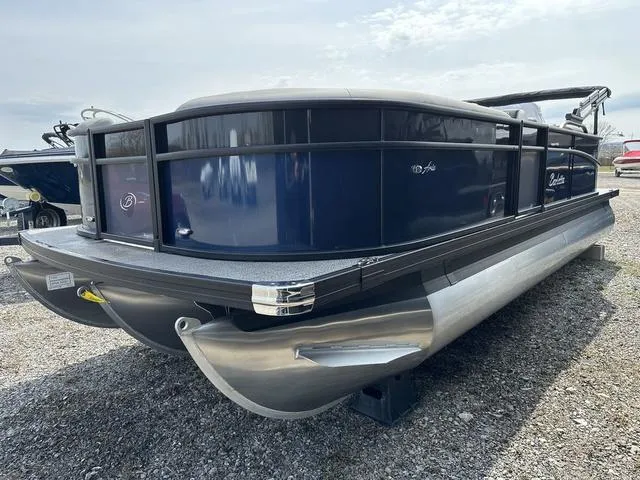 Slide: The Image of 2025 Barletta Boats A22QC pontoon boat on gravel lot, side view. - 4