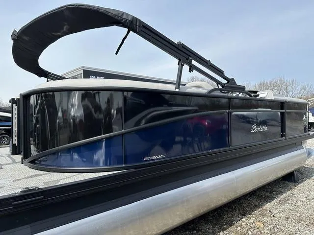 Slide: The Image of 2025 Barletta Boats A22QC pontoon boat with sleek black and blue design. - 5