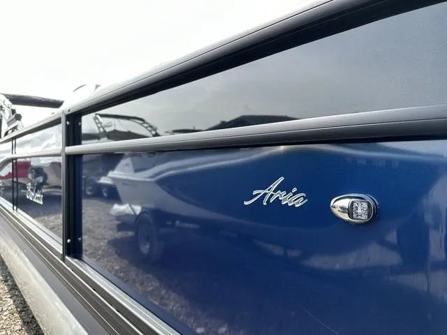 Slide: The Image of 2025 Barletta Boats A22QC Aria model, sleek blue exterior with chrome accents. - 6