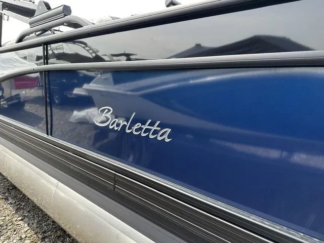 Slide: The Image of 2025 Barletta A22QC boat, sleek blue exterior with elegant branding. - 7