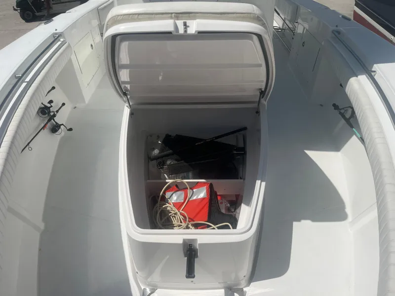 Slide: The Image of 2006 Southport 28 Center Console boat with open storage compartment, fishing gear visible. - 15