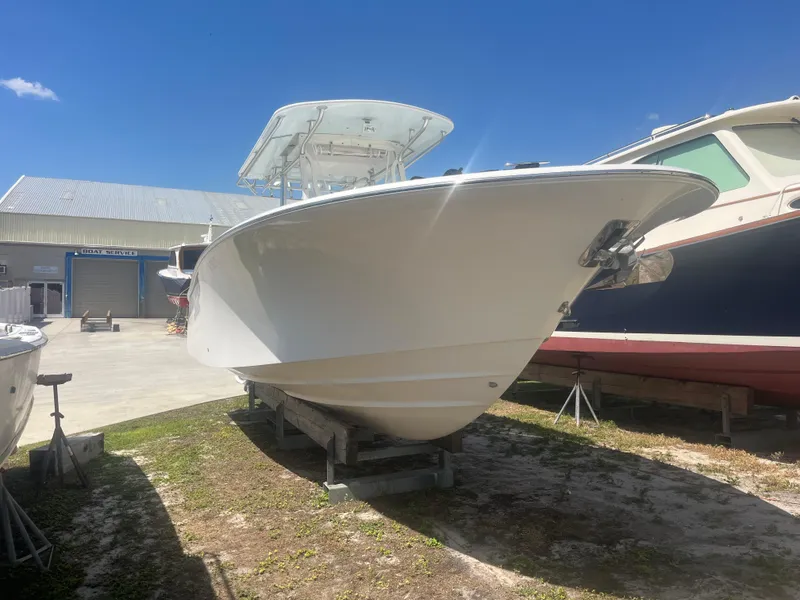 Slide: The Image of 2006 Southport 28 Center Console boat on display under clear blue sky. - 2
