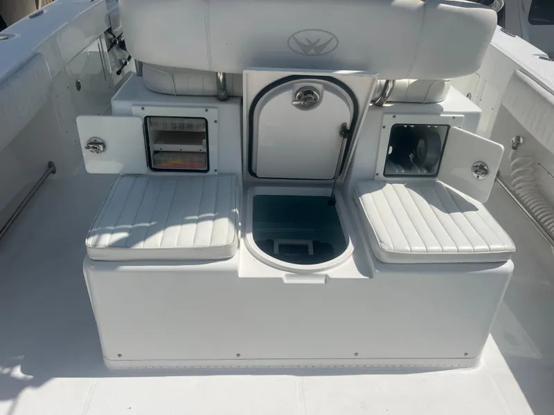 Slide: The Image of 2006 Southport 28 Center Console boat interior with storage compartments and seating. - 23