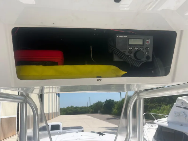 Slide: The Image of Storage compartment in a 2006 Southport 28 Center Console boat with radio equipment. - 24