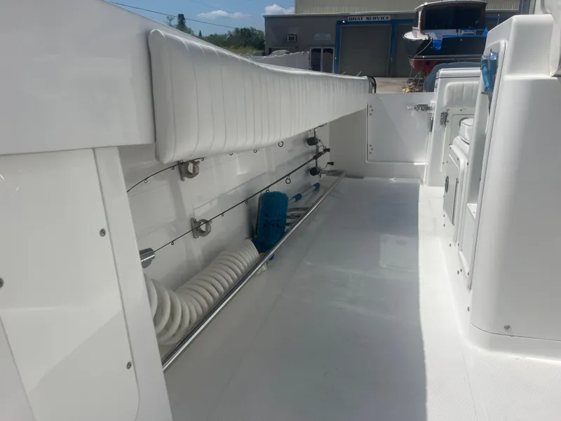 Slide: The Image of 2006 Southport 28 Center Console boat interior with white seating and storage. - 25