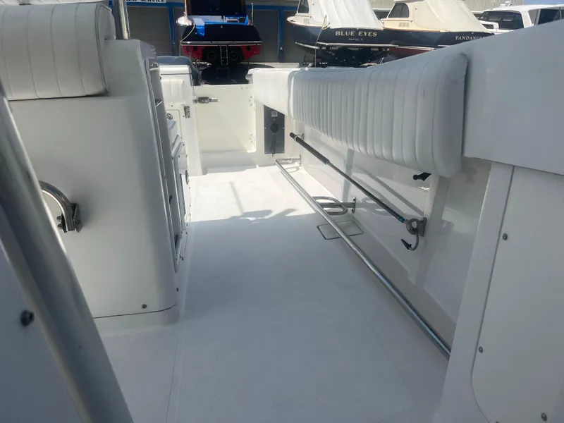 Slide: The Image of 2006 Southport 28 Center Console boat interior with white seating and clean deck. - 26
