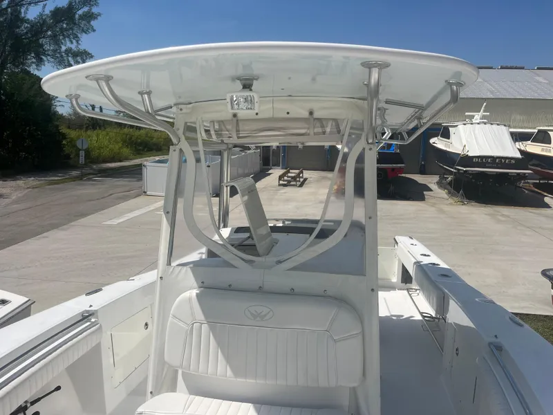 Slide: The Image of 2006 Southport 28 Center Console boat with T-top in a marina setting. - 27