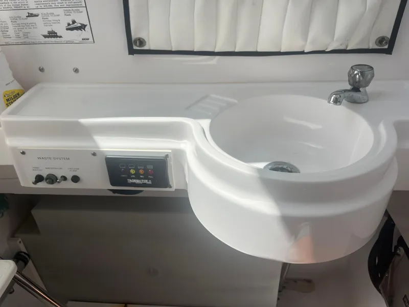 Slide: The Image of 2006 Southport 28 Center Console boat sink and control panel. - 29