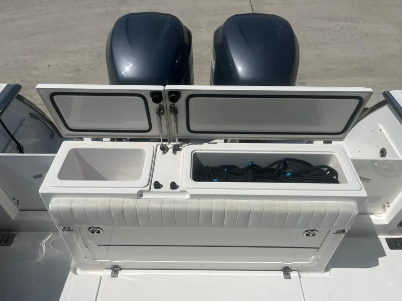 Slide: The Image of 2006 Southport 28 Center Console boat with open storage compartments and dual engines. - 31