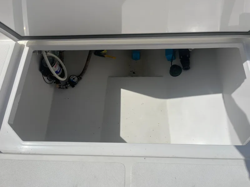 Slide: The Image of Open storage compartment on a 2006 Southport 28 Center Console boat. - 32