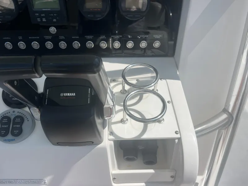 Slide: The Image of Control panel of 2006 Southport 28 Center Console boat with Yamaha throttle and cup holders. - 35