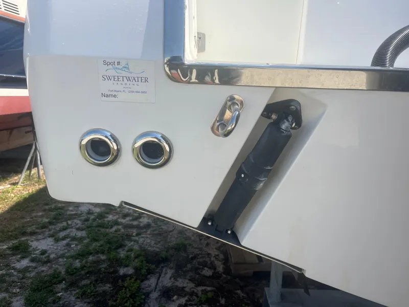 Slide: The Image of 2006 Southport 28 Center Console boat stern with trim tabs and exhaust ports. - 38