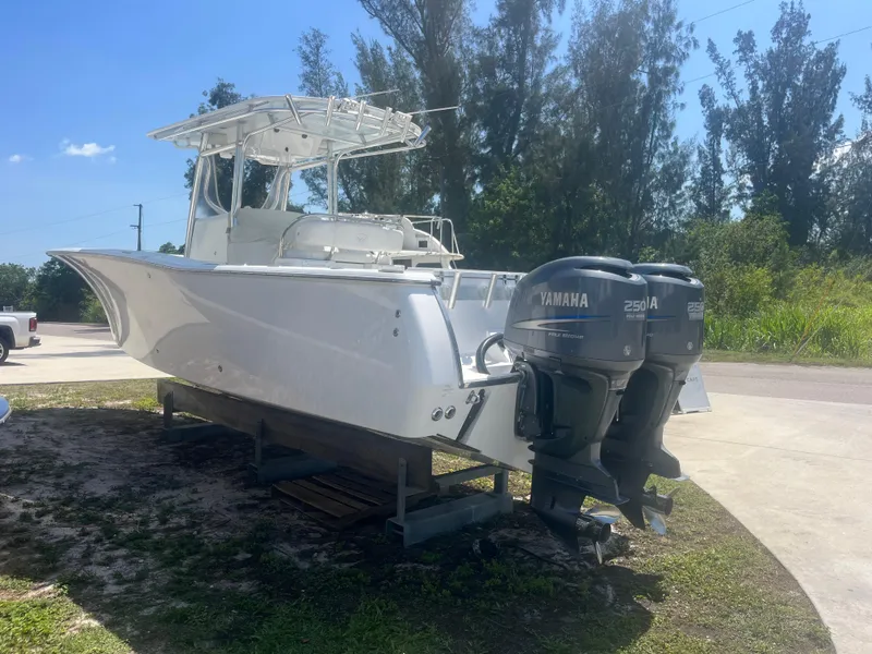 Slide: The Image of 2006 Southport 28 Center Console boat with twin Yamaha 250 engines, parked outdoors. - 4