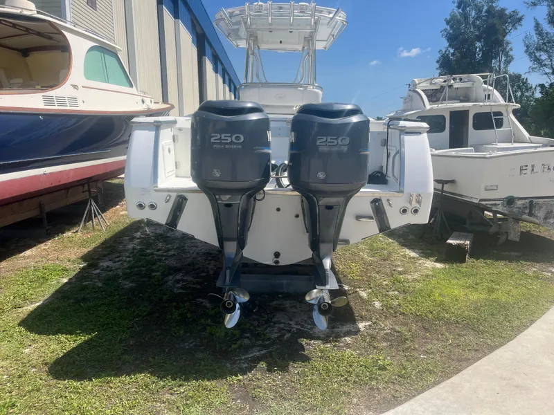 Slide: The Image of 2006 Southport 28 Center Console boat with twin 250 horsepower engines, parked outdoors. - 5