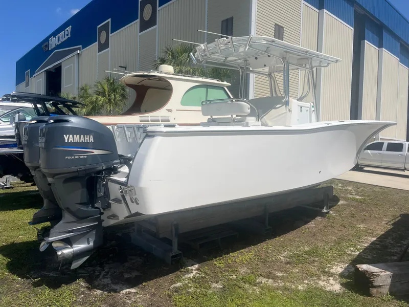 Slide: The Image of 2006 Southport 28 Center Console boat with Yamaha outboard, parked outdoors near a building. - 6