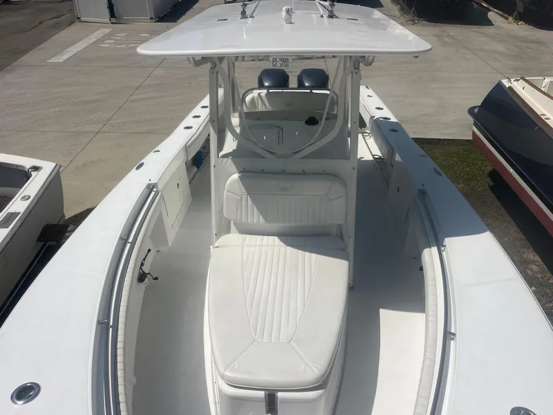 Slide: The Image of 2006 Southport 28 Center Console boat with white seating and spacious deck. - 7
