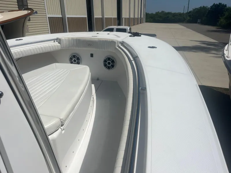 Slide: The Image of 2006 Southport 28 Center Console boat with white seating and speakers, docked outdoors. - 8