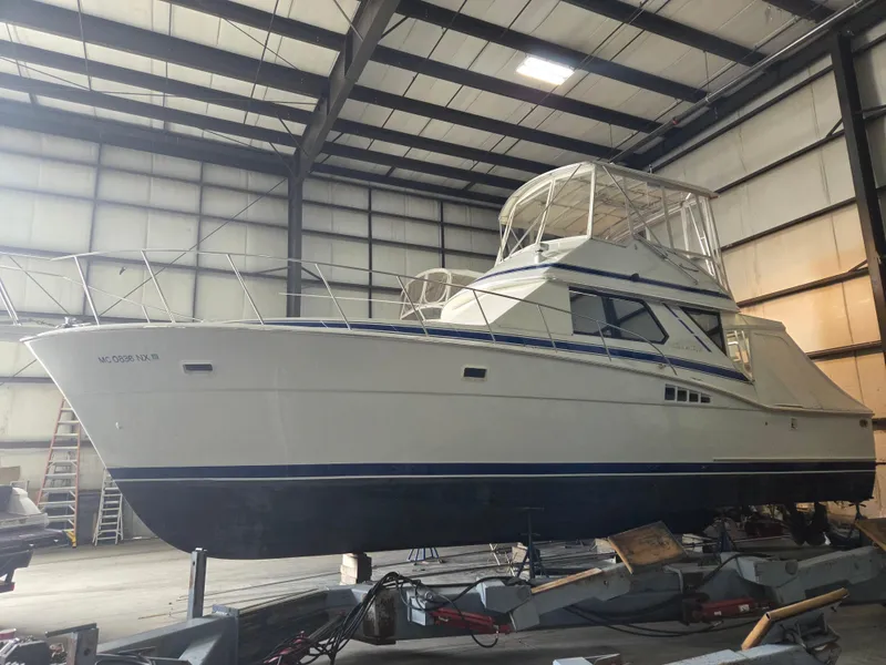 The Image of 1989 Chris-Craft 42 Sportfish Commander in indoor storage facility. - 0