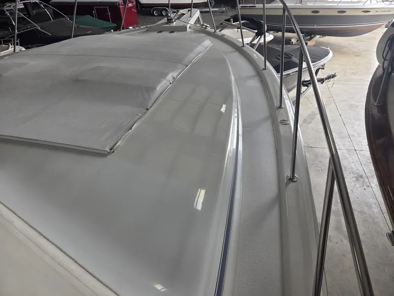 Slide: The Image of 1989 Chris-Craft 42 Sportfish Commander boat deck with railing in a showroom. - 10