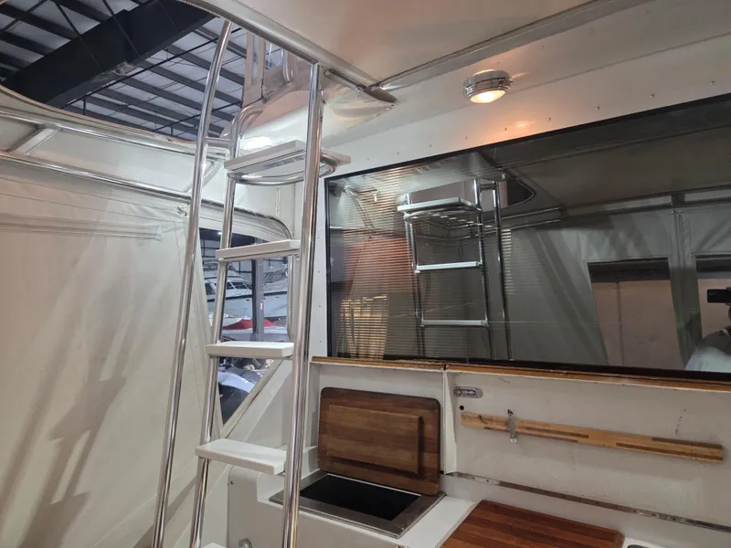 Slide: The Image of 1989 Chris-Craft 42 Sportfish Commander interior with ladder and wooden countertops. - 12