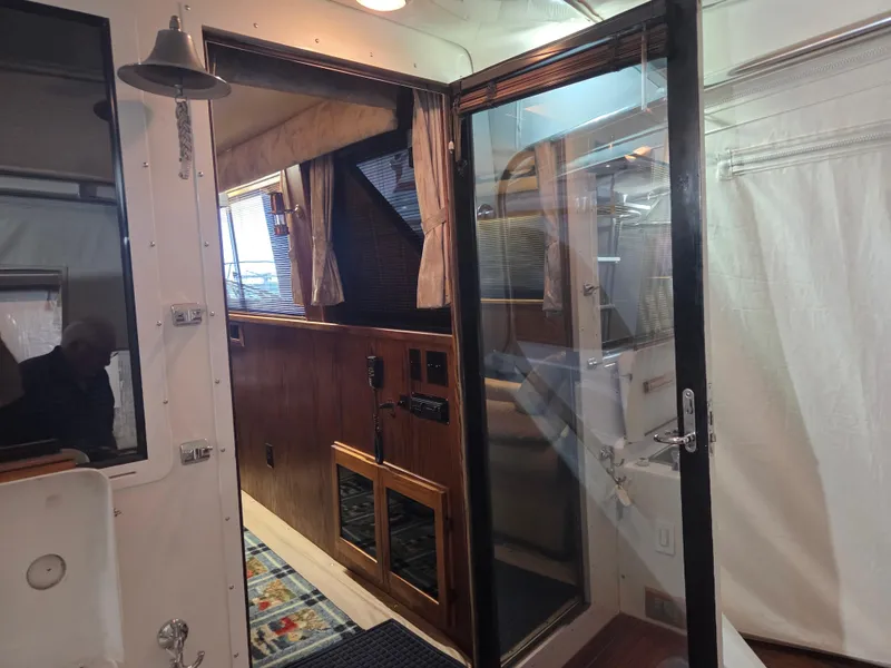 Slide: The Image of Interior view of 1989 Chris-Craft 42 Sportfish Commander yacht with wooden paneling. - 14