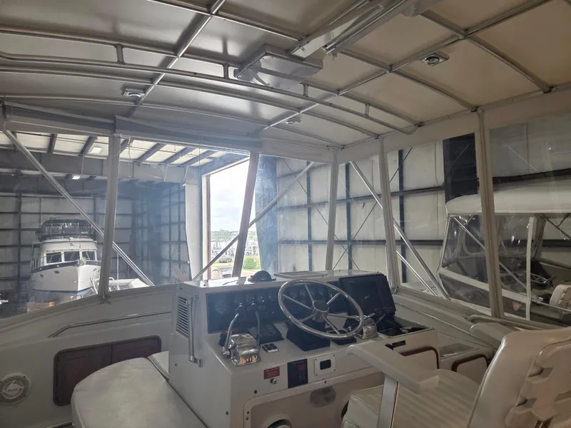 Slide: The Image of 1989 Chris-Craft 42 Sportfish Commander interior view in a boat storage facility. - 17