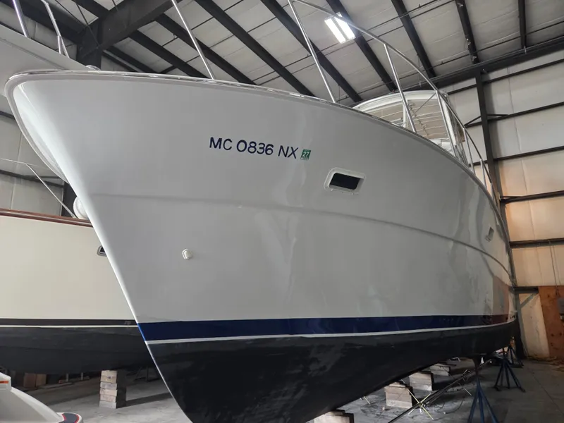 Slide: The Image of 1989 Chris-Craft 42 Sportfish Commander in storage, showcasing sleek hull design. - 2