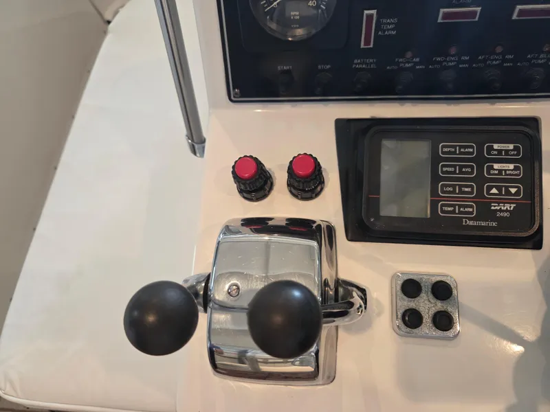 Slide: The Image of Control panel of 1989 Chris-Craft 42 Sportfish Commander with throttle and navigation display. - 20