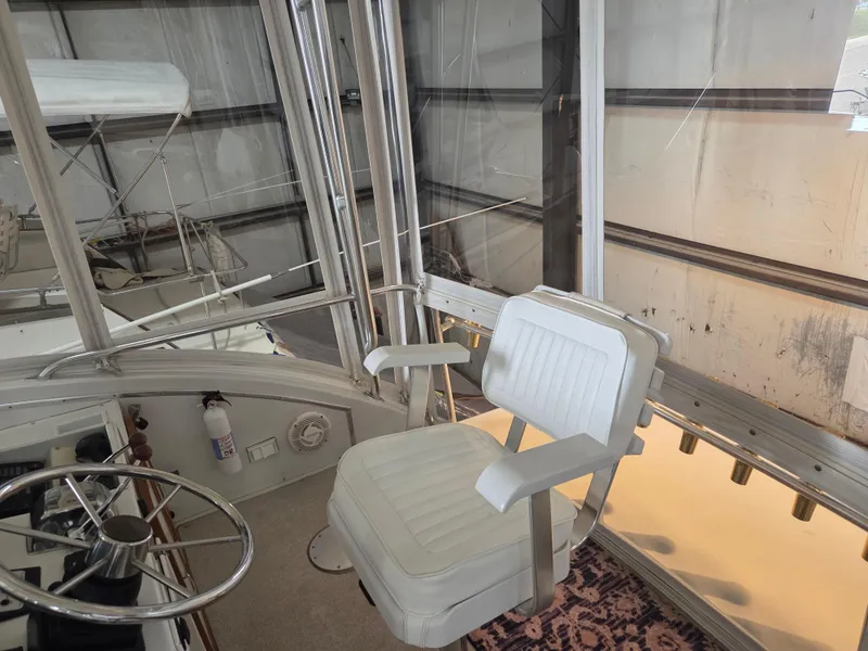 Slide: The Image of Captain's chair on 1989 Chris-Craft 42 Sportfish Commander, enclosed helm area. - 22